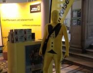 Raiffeisen Bank Morphsuits in gelb mit Tuxedo Aufdruck